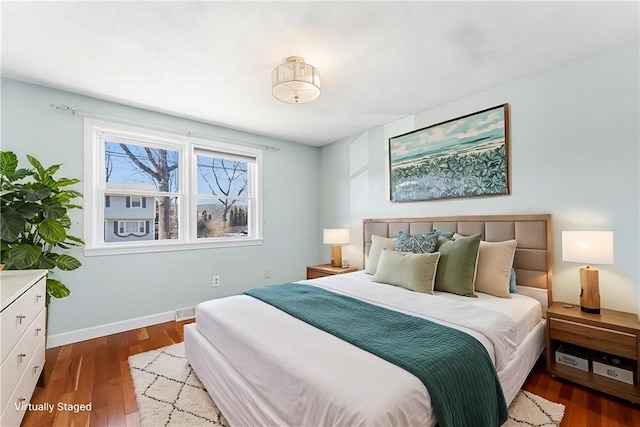 bedroom featuring wood finished floors and baseboards