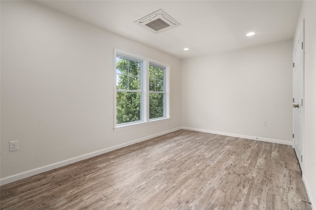 unfurnished room with recessed lighting, baseboards, and wood finished floors