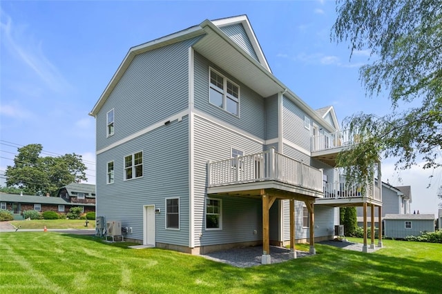 back of house with a lawn and central AC unit