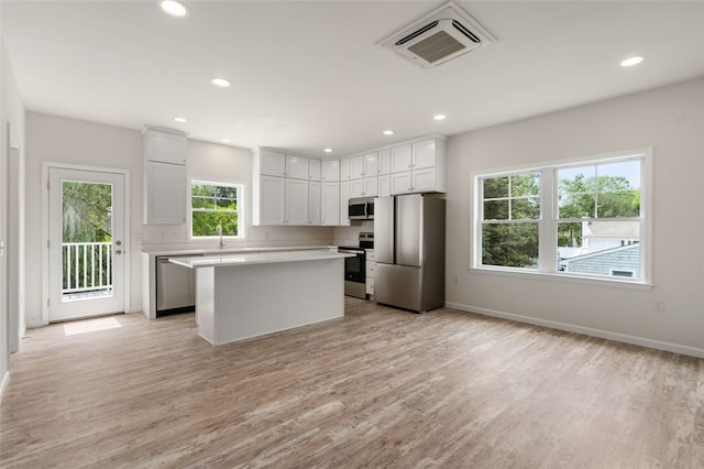 kitchen with visible vents, light wood-style floors, appliances with stainless steel finishes, and light countertops