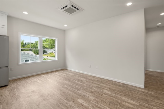 unfurnished room featuring recessed lighting, visible vents, baseboards, and light wood-style floors