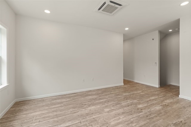 unfurnished room featuring visible vents, recessed lighting, light wood-type flooring, and baseboards