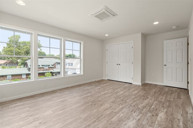 unfurnished bedroom with visible vents, baseboards, recessed lighting, light wood-style floors, and a closet