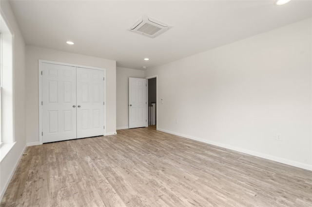 unfurnished bedroom with visible vents, baseboards, light wood-type flooring, recessed lighting, and a closet