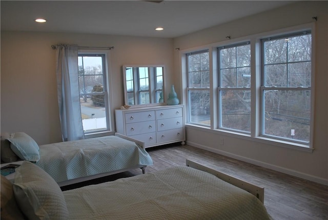 bedroom with recessed lighting, baseboards, and wood finished floors