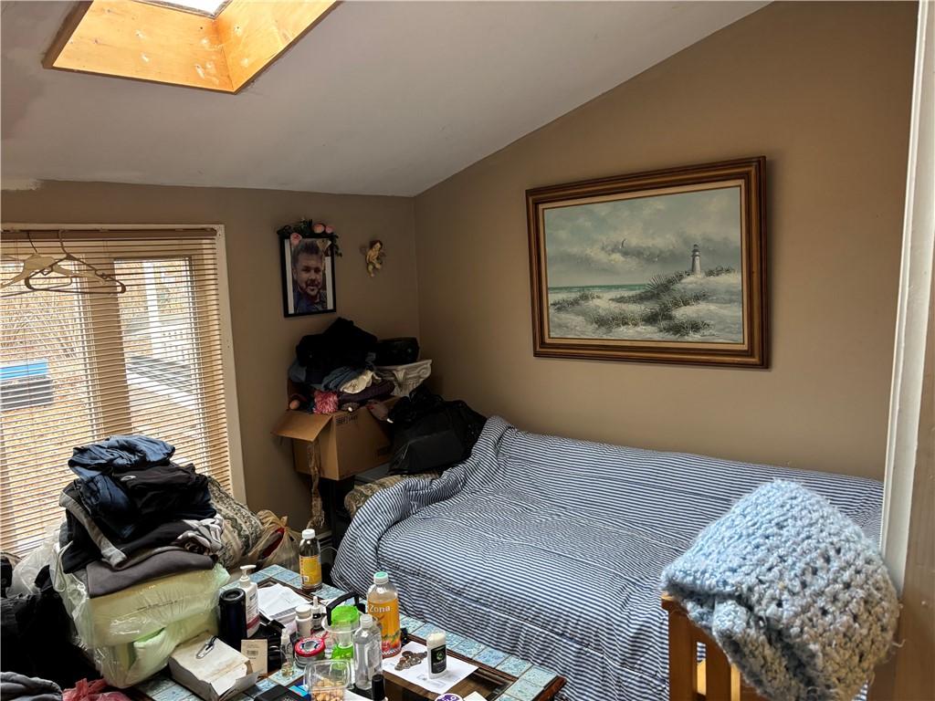 bedroom featuring lofted ceiling with skylight