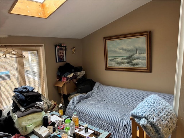 bedroom featuring lofted ceiling with skylight