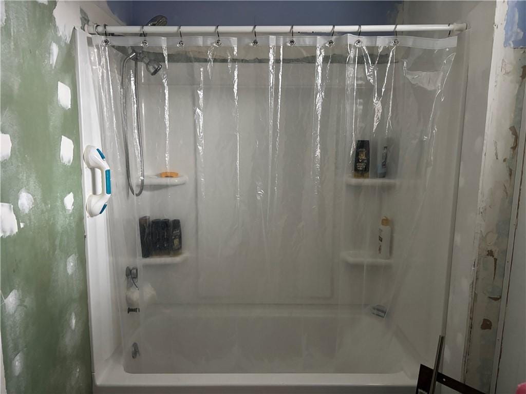 full bath featuring shower / tub combo with curtain