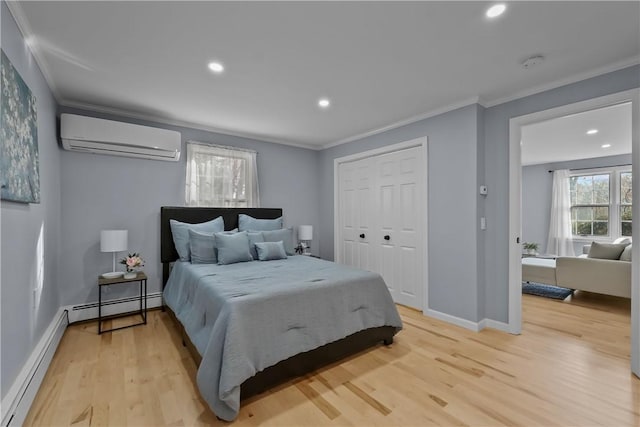 bedroom featuring light wood finished floors, ornamental molding, a wall mounted AC, and a baseboard radiator