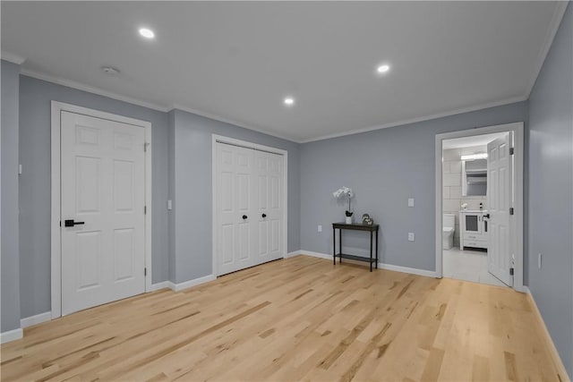 unfurnished bedroom featuring recessed lighting, baseboards, ornamental molding, light wood-type flooring, and ensuite bath