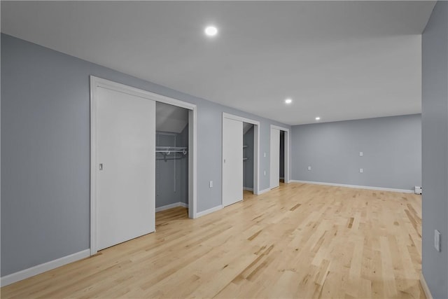 unfurnished bedroom with light wood-style floors, recessed lighting, and baseboards