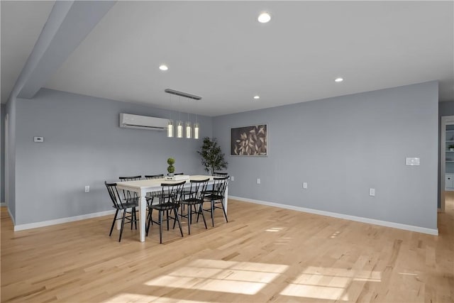 dining room featuring baseboards, a wall mounted AC, recessed lighting, and light wood-style floors