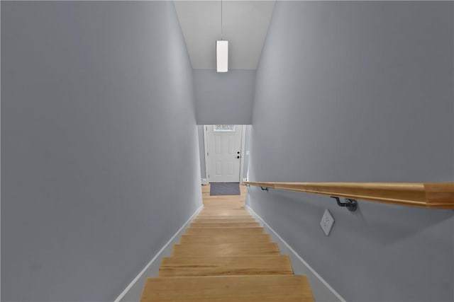 stairway with baseboards and wood finished floors