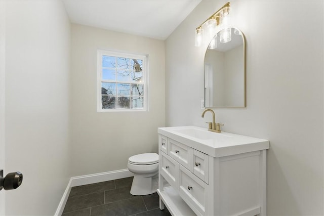 bathroom with tile patterned floors, vanity, toilet, and baseboards