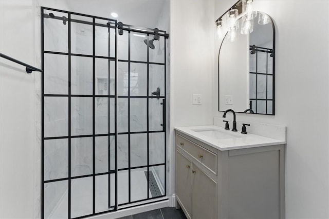 full bath with a tile shower and vanity