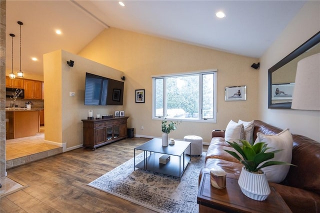 living area with lofted ceiling, recessed lighting, wood finished floors, and baseboards