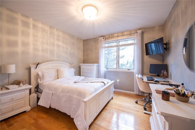 bedroom featuring light wood-type flooring and baseboards