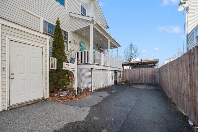 view of side of property featuring fence