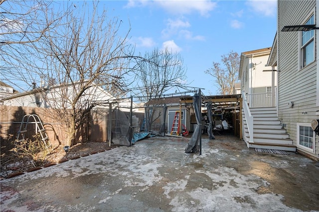 view of yard with an outbuilding, stairway, and a fenced backyard