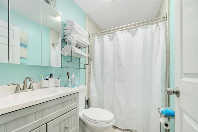 bathroom featuring vanity, toilet, and a shower with curtain