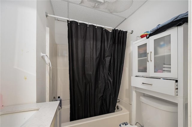 full bathroom featuring toilet, shower / bath combo, a paneled ceiling, and vanity