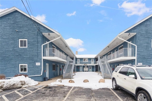 view of road with stairs and driveway