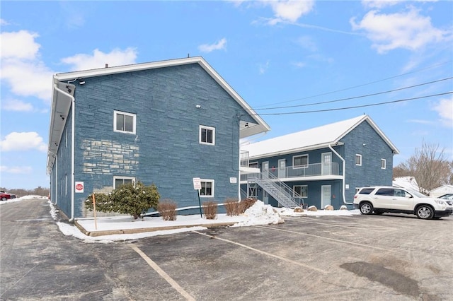 exterior space with uncovered parking and stairs