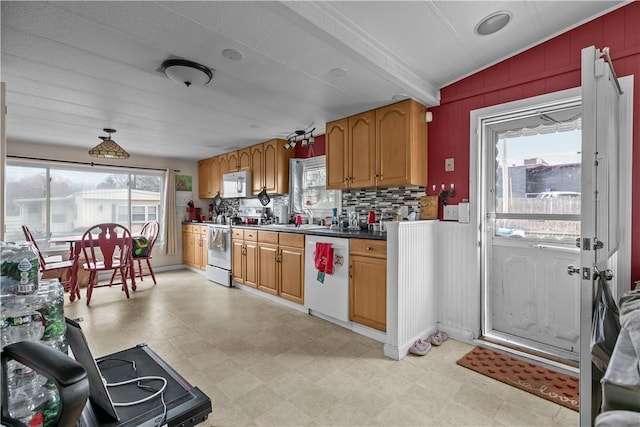 kitchen with tasteful backsplash, white appliances, a sink, and light floors