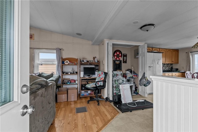 home office featuring vaulted ceiling