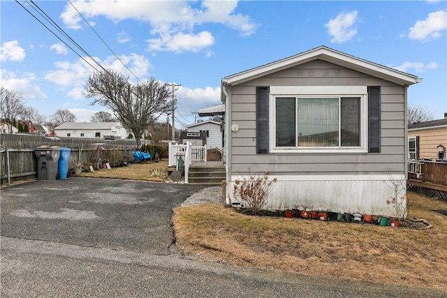 view of front of house featuring fence