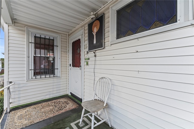 view of exterior entry featuring covered porch