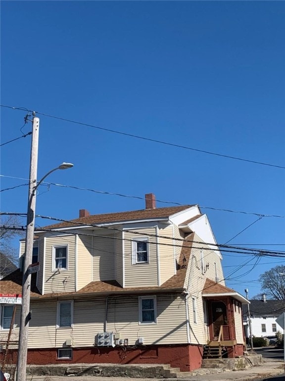 view of home's exterior with roof with shingles