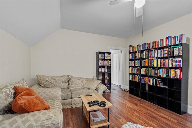 living area featuring vaulted ceiling, ceiling fan, and wood finished floors