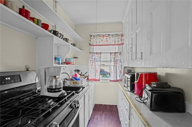 kitchen with stainless steel appliances, dark wood-type flooring, white cabinetry, light countertops, and open shelves