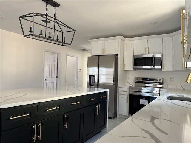 kitchen featuring dark cabinets, stainless steel appliances, a sink, visible vents, and white cabinets