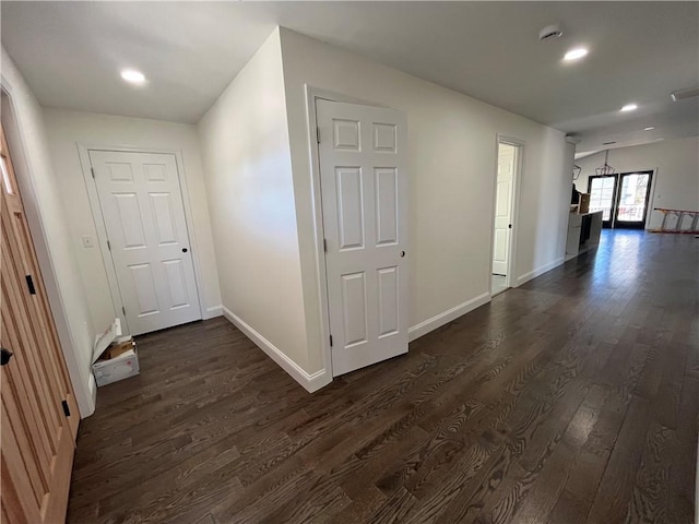 hallway with recessed lighting, dark wood finished floors, and baseboards