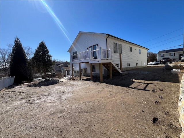 exterior space with stairs, fence, and a wooden deck