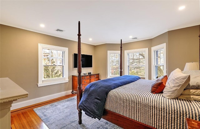 bedroom featuring wood-type flooring, visible vents, baseboards, and recessed lighting