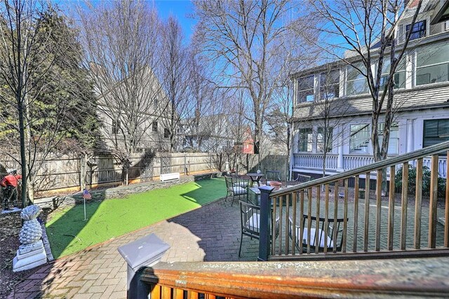 view of yard with a fenced backyard and a deck