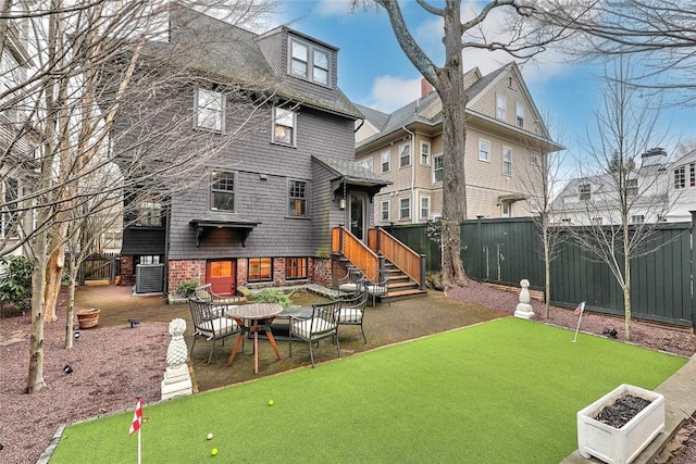 rear view of house featuring a patio area and a fenced backyard