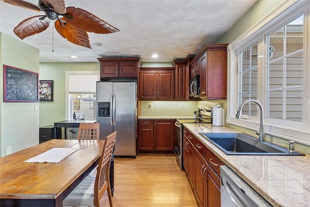 kitchen with light wood finished floors, stainless steel appliances, recessed lighting, a sink, and ceiling fan