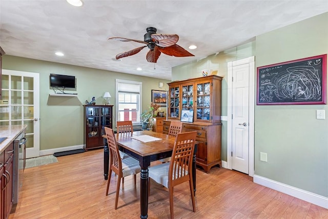 dining area with a ceiling fan, recessed lighting, light wood-style flooring, and baseboards