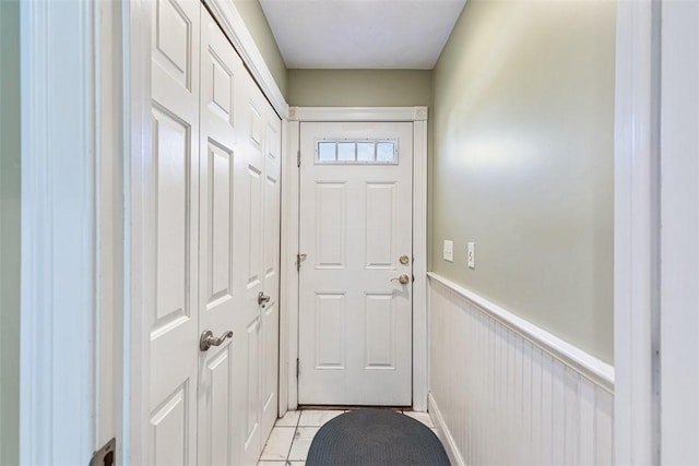 entryway featuring a wainscoted wall and light tile patterned flooring