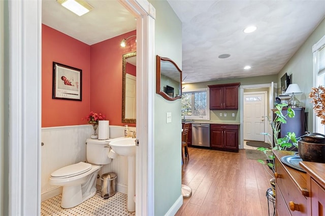 bathroom featuring a wainscoted wall, wood finished floors, toilet, and recessed lighting