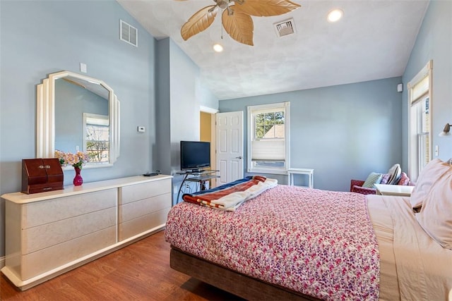 bedroom featuring recessed lighting, visible vents, vaulted ceiling, and wood finished floors