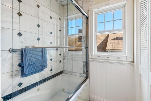 bathroom featuring shower / bath combination with glass door