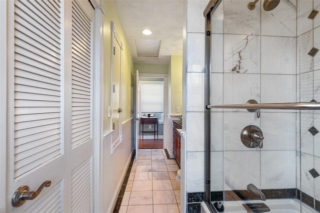 full bath with a stall shower, baseboards, a closet, and vanity