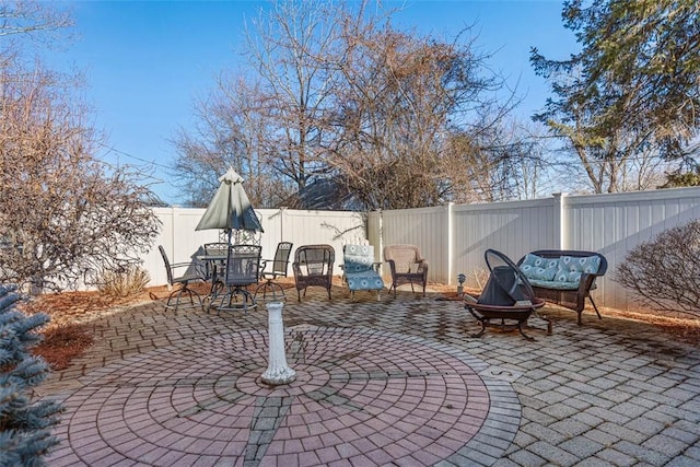 view of patio / terrace with a fenced backyard and a fire pit