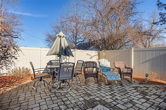 view of patio featuring a fenced backyard and outdoor dining area