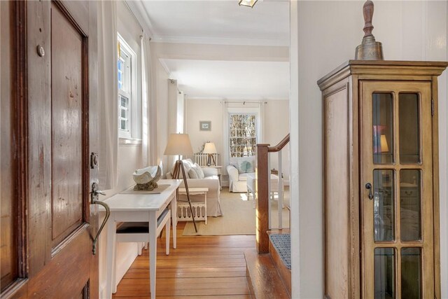 entryway featuring ornamental molding, stairs, and hardwood / wood-style flooring